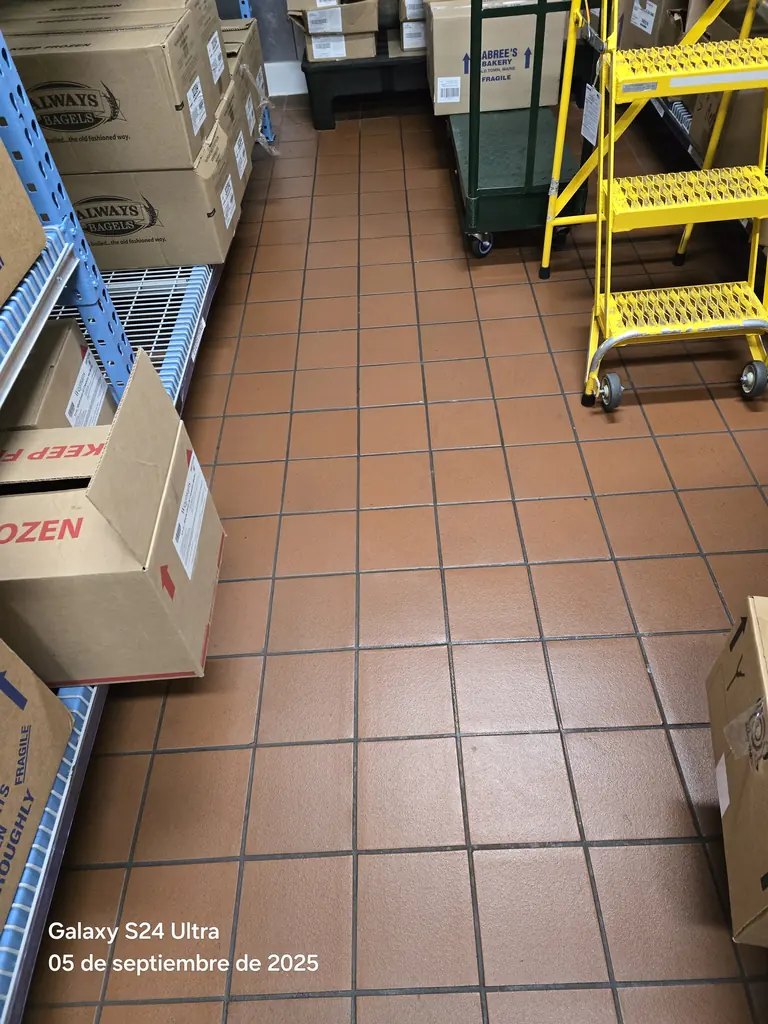 Stockroom floor cleaned between pallets and racking