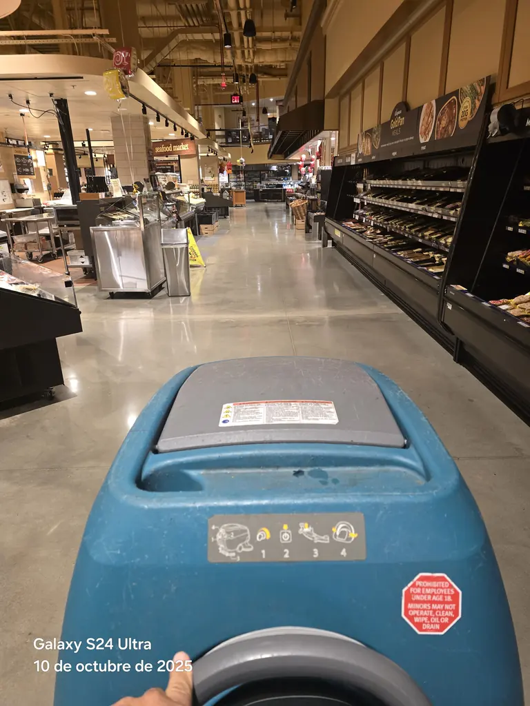 Auto-scrubber running a store aisle during a night shift