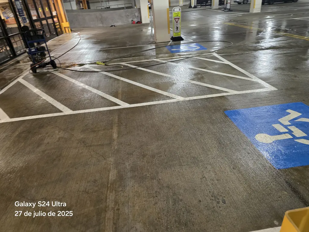 Pressure washing a parking garage with the machine running